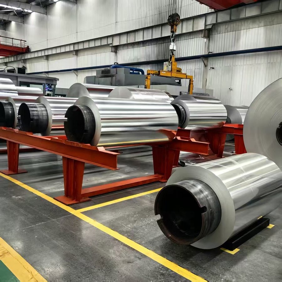 Polished aluminum coils stacked on red racks